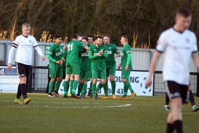 Bedworth United celebrate scoring the only goal of the game as they condemned Corby Town to a third defeat in a row. Picture by Alison Bagley