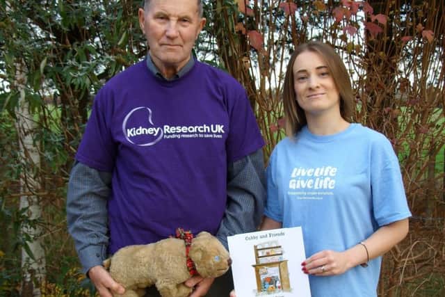 David and Kathryn with Cubby and the new book. NNL-180201-113808005