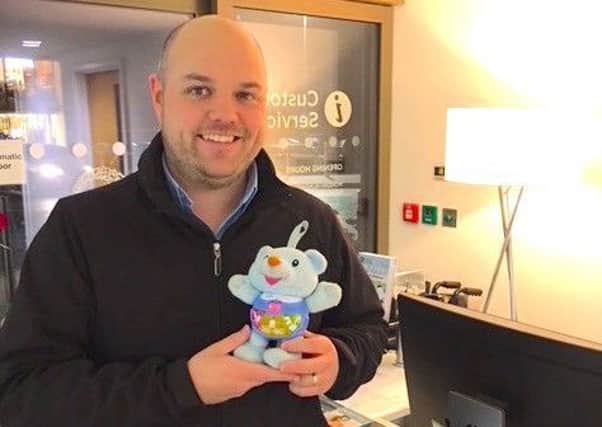 Robert Hunt collects one of the toys lost at Rushden Lakes