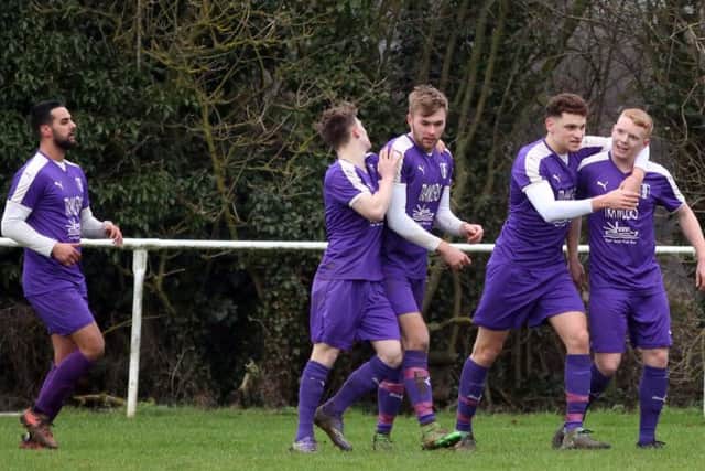 The Daventry Town players celebrate one of their goals in the win at Rothwell Corinthians