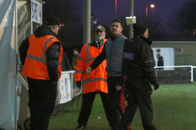Kettering Town boss Marcus Law pictured during a furious exchange with a fan after the 1-1 draw with Kings Langley at Latimer Park. Pictures by Peter Short