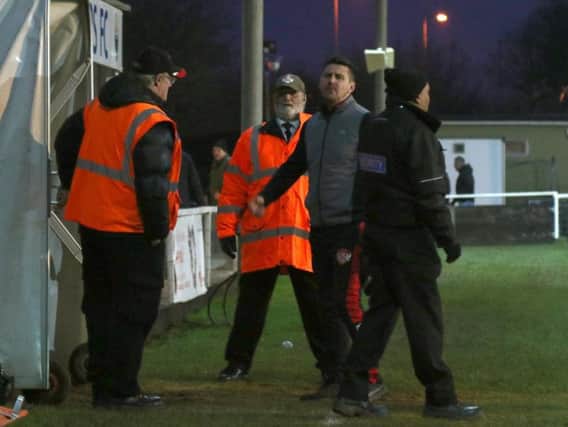 Kettering Town boss Marcus Law pictured during a furious exchange with a fan after the 1-1 draw with Kings Langley at Latimer Park. Pictures by Peter Short