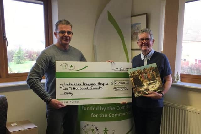 Tom presenting a cheque for £2,000 to Lakelands Hospice