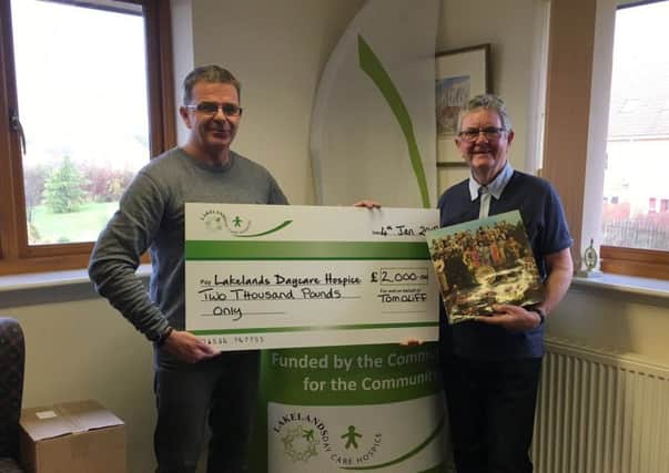 Tom presenting a cheque for Â£2,000 to Lakelands Hospice