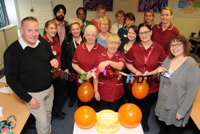 Staff celebrate the anniversary. NNL-180116-152452005