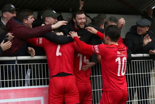 Mathew Stevens celebrates his goals with the travelling fans during Kettering Town's 4-2 success at Merthyr Town. Pictures by Peter Short