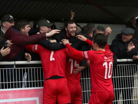 Mathew Stevens celebrates his goals with the travelling fans during Kettering Town's 4-2 success at Merthyr Town. Pictures by Peter Short
