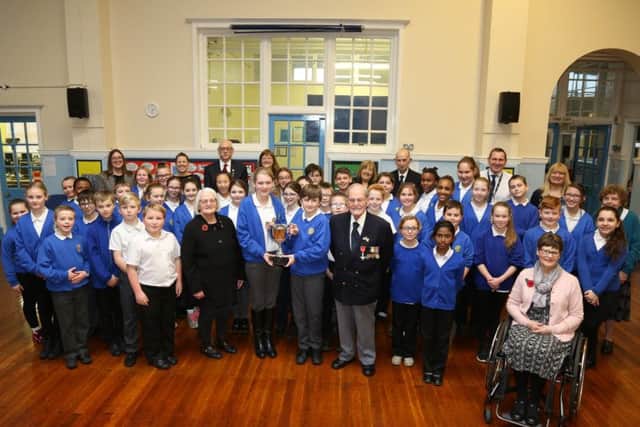 Pupils with the cup and members of Rushden's RBL yesterday (Tuesday)