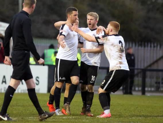 Steven Leslie takes the congratulations after scoring from the penalty spot but Corby Town were unable to hold on to their lead as they were beaten 2-1 by Frickley Athletic. Pictures by Alison Bagley