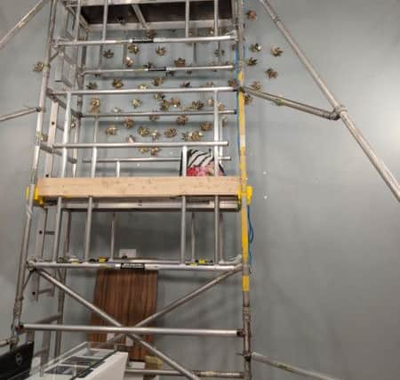 The gold leaf artwork during its installation. NNL-180131-122457005