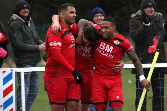 Goalscorer Mathew Stevens (centre) is congratulated by Rene Howe and Aaron O'Connor after he gave the Poppies the lead in their 3-1 win over Biggleswade Town last weekend. Picture by Peter Short