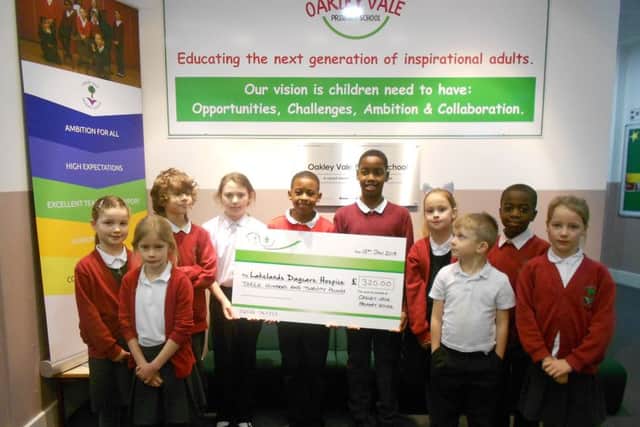Pupils from Oakley Vale Primary School with the cheque for Lakelands