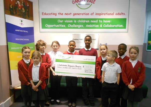 Pupils from Oakley Vale Primary School with the cheque for Lakelands