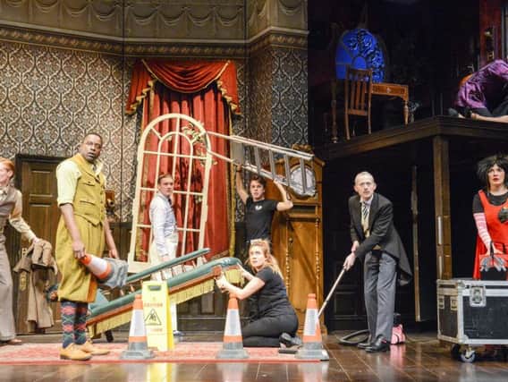 The cast of The Play That Goes Wrong during a chaotic moment.