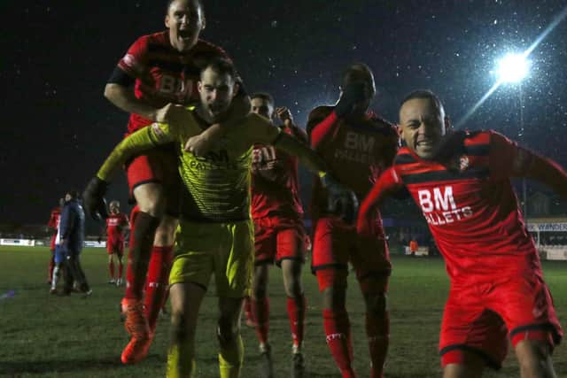 Kettering Town's players celebrate after their penalty shoot-out success over AFC Rushden & Diamonds at Latimer Park. Pictures by Peter Short