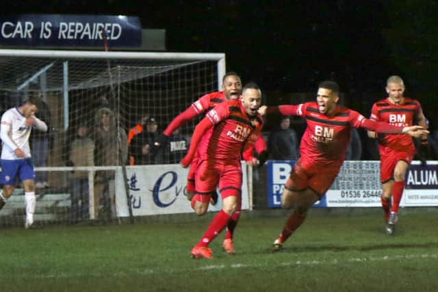 Rhys Hoenes heads off to celebrate after he put Kettering 3-2 up