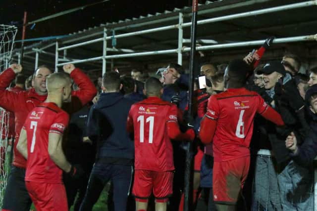 Kettering Town's players and fans celebrate their penalty shoot-out success over AFC Rushden & Diamonds. Pictures by Peter Short