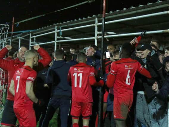 Kettering Town's players and fans celebrate their penalty shoot-out success over AFC Rushden & Diamonds. Pictures by Peter Short