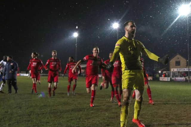 Goalkeeper Paul White shows his delight after Kettering secured victory