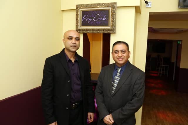 Shomor Miah and Sanjai Tailor by the pay desk at Pop Central