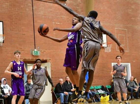 Dinari Williams-Brown goes for the basket for Titans Purple