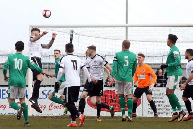Paul Malone gets up to win a header at Steel Park