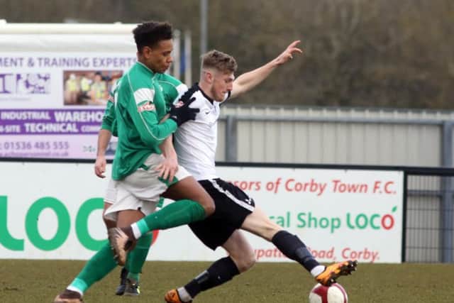 Connor Kennedy holds a challenge from a Loughborough player