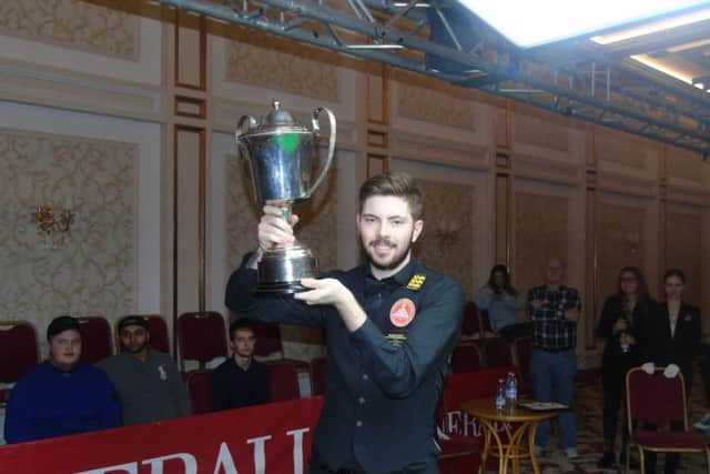 Harvey Chandler shows off his trophy after he won the EBSA European Championship to secure a place on the World Snooker Tour. Picture courtesy of EBSA