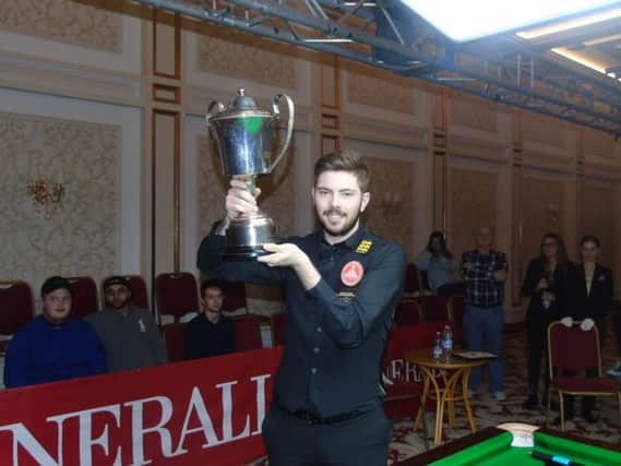 Harvey Chandler shows off his trophy after he won the EBSA European Championship to secure a place on the World Snooker Tour. Picture courtesy of EBSA