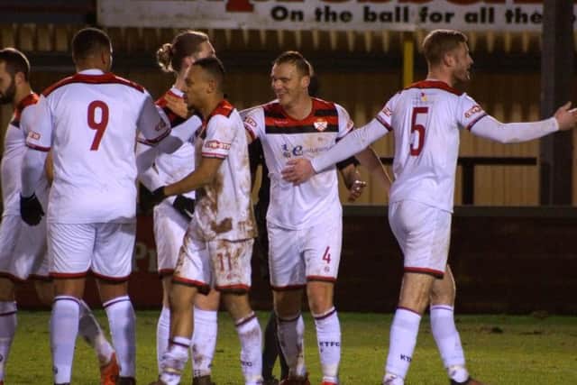 Kettering Town celebrate one of their goals during Tuesday's fine 3-0 success at Tiverton Town. The Poppies are back on the road at Chesham United tomorrow. Picture by Peter Short