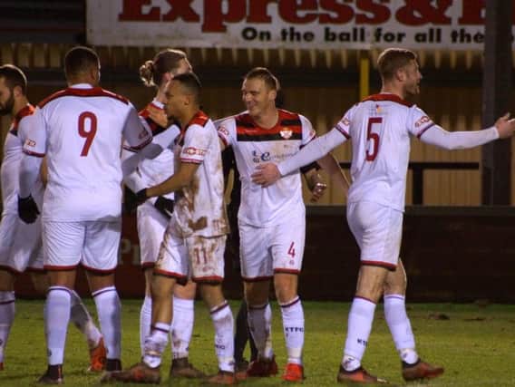 Kettering Town celebrate one of their goals during Tuesday's fine 3-0 success at Tiverton Town. The Poppies are back on the road at Chesham United tomorrow. Picture by Peter Short