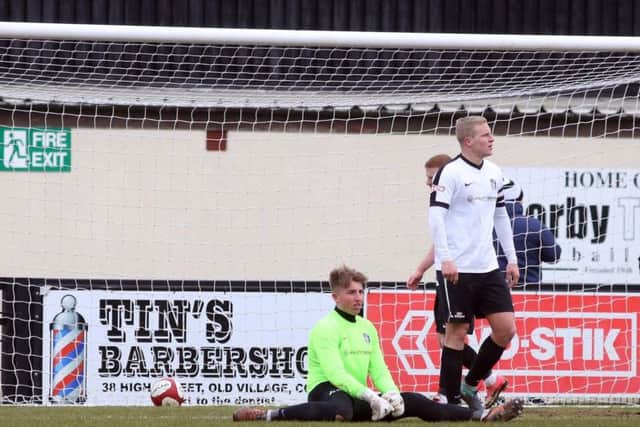 Corby goalkeeper Sam Wilson and defender Jamie Anton look dejected following Gresley's second goal
