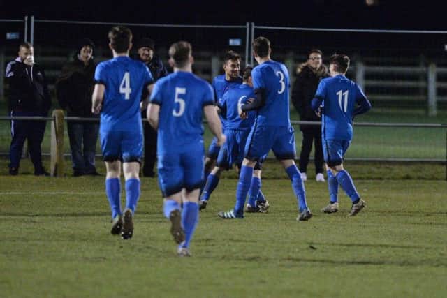 Dan White takes the congratulations after he scored in Desborough Town's 3-1 derby success at Harborough Town in midweek. Picture by Andrew Carpenter