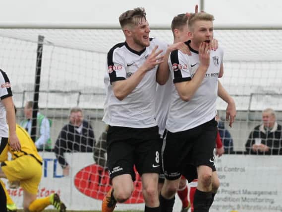Jake Bettles celebrates one of his second-half strikes for Corby Town in the win over Chasetown