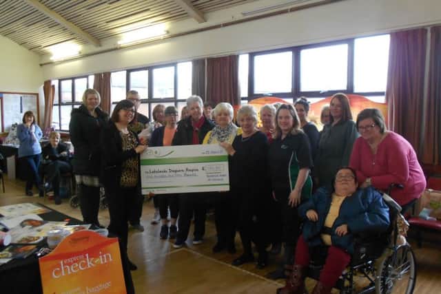 Members of Slimming World presenting the cheque to Marina from Lakelands Hospice