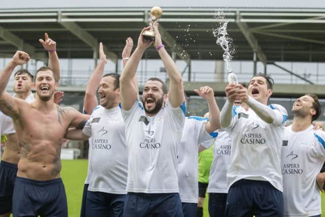 Winning captain lifts Shayne Ward the Niamh's Next Step charity trophy