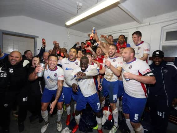 The AFC Rushden & Diamonds squad enjoy the moment in the home dressing-room after they secured promotion with a 7-1 victory over Aylesbury at Hayden Road. Pictures by Alison Bagley