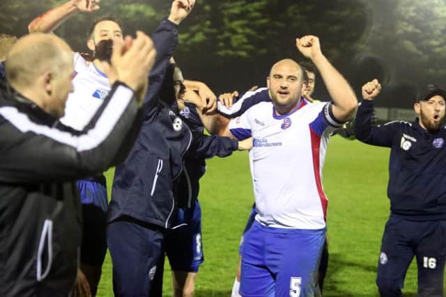 Captain Liam Dolman leads the celebrations after AFC Rushden & Diamonds sealed promotion on Tuesday night. Picture by Alison Bagley