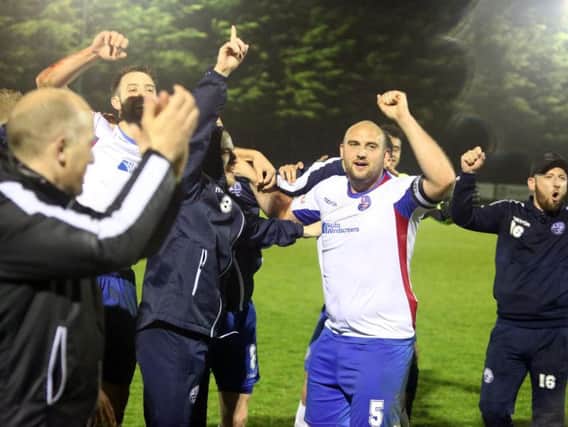 Captain Liam Dolman leads the celebrations after AFC Rushden & Diamonds sealed promotion on Tuesday night. Picture by Alison Bagley