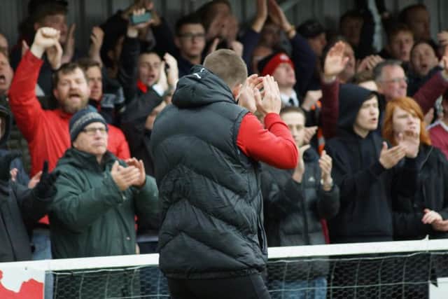 Kettering Town manager Marcus Law applauds the fans following Kettering Town's 6-2 victory over Farnborough. Pictures by Peter Short