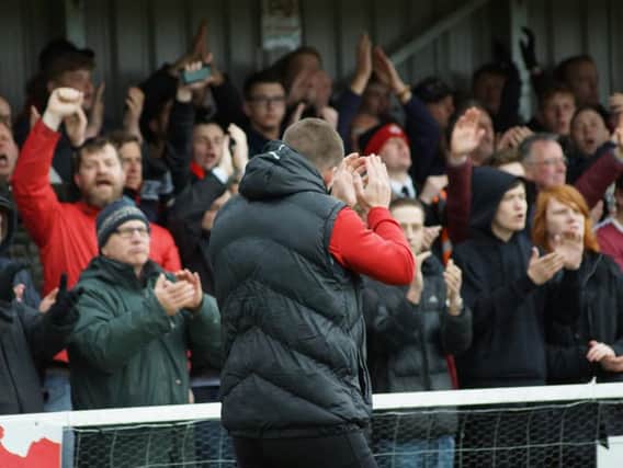 Kettering Town manager Marcus Law applauds the fans following Kettering Town's 6-2 victory over Farnborough. Pictures by Peter Short