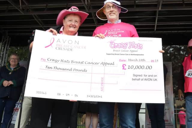 Glennis receiving a cheque for Â£10,000 from Avon