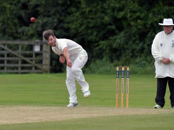 Jake Bindley sends down a delivery during Desboroughs win at East Haddon. Bindley went on to hit an unbeaten 153 to guide high-flying Desborough to a six-wicket victory in Division One. Picture by Dave Ikin