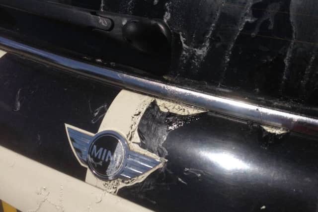 The rear windscreen of the car has been damaged by the corrosive substance NNL-180622-121932005