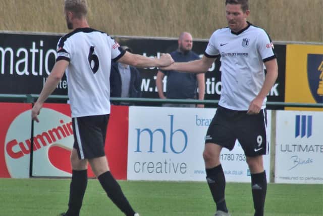 Gary Mulligan congratulates goalscorer Elliot Sandy after he grabbed Corby Town's first goal in the 2-1 friendly success at Stamford. Picture by David Tilley