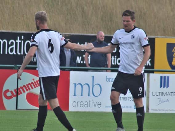 Gary Mulligan congratulates goalscorer Elliot Sandy after he grabbed Corby Town's first goal in the 2-1 friendly success at Stamford. Picture by David Tilley