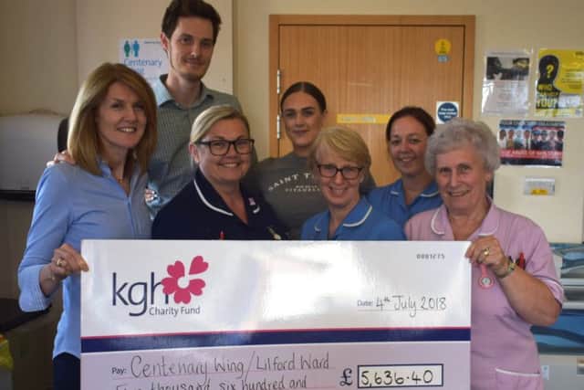 Johnny's family present the cheque.