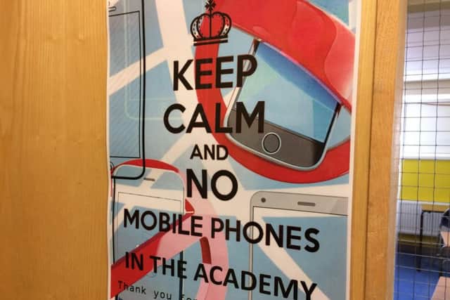 Posters advertising the ban on mobiles are placed around the Academy