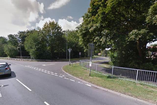A woman was pushed to the ground on Lings Way and robbed of her backpack.
