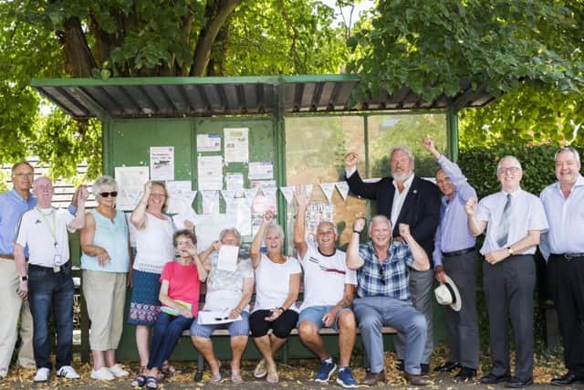 Celebrating the launch of the new bus service at the bus stop in Cogenhoe